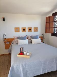 a bedroom with a bed with a tray of food on it at LA TAGORA Conect with the nature & relax in Icod de los Vinos