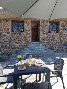 a table with food and drinks on a patio at LA TAGORA Conect with the nature & relax in Icod de los Vinos