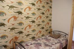 a bedroom with a dinosaur wallpaper on the wall at Casa Rural Anita in Torre Baja