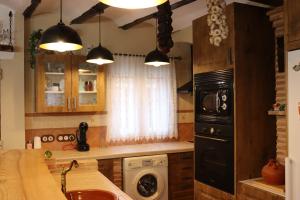 a kitchen with a sink and a stove top oven at Casa Rural Anita in Torre Baja