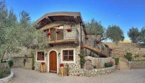 a large stone house with a balcony on top of it at OLIVE QUEEN Rustic Apartment 1 in Bar