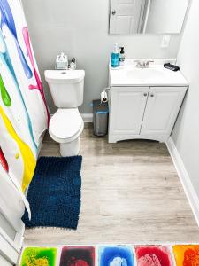 a bathroom with a toilet and a sink at IvyLand Pines in Cleveland Heights