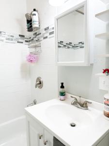 a white bathroom with a sink and a mirror at IvyLand Pines in Cleveland Heights