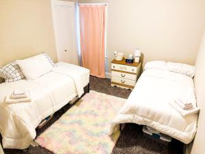 a bedroom with two beds and a rug at IvyLand Pines in Cleveland Heights