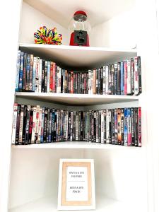 a book shelf filled with dvds at IvyLand Pines in Cleveland Heights