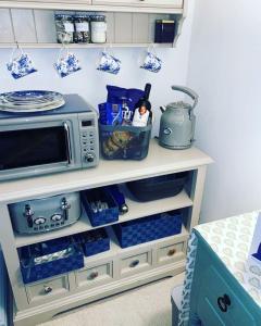 a microwave on a shelf in a kitchen at The Suite at Solway View in Cockermouth