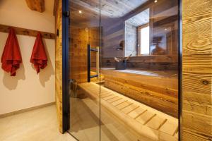 a sauna with a glass door in a bathroom at Steinberger Hof Alm inkl. Chiemgau Karte in Ruhpolding +28 photos