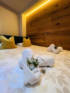 a bedroom with a bed with towels on it at Apartamentos Prestige Málaga Suites in Málaga