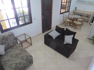 a living room with a couch and a table at Casa na Rua da Praia com TV e Wi-fi in Pontal do Paraná +15 photos