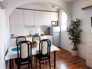 a kitchen with a table and chairs in a room at Fira Suites in Barcelona