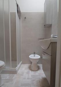 a bathroom with a shower and a toilet and a sink at Villa Marisole in Torre Canne