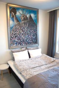 a bedroom with a large painting above a bed at MM City Apartment Next to Arena in Tampere