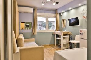a small living room with a couch and a table at Apollo 3 - Luxury Apartment (City Center Studio) in Katerini