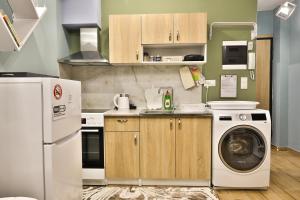 a kitchen with a washing machine and a washer at Apollo 3 - Luxury Apartment (City Center Studio) in Katerini