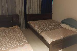 a small room with two beds in it at stunning 2-bedroom flat in Ajman 