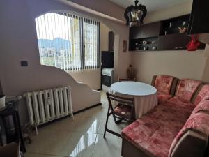 a living room with a couch and a table at Dabnika in Vratsa