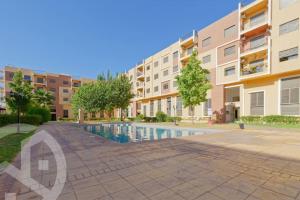 une image d'un complexe d'appartements avec une piscine dans l'établissement Chez ASSYL: résidence avec 3 piscines, à Marrakech