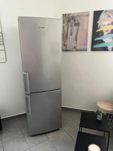 a stainless steel refrigerator in a kitchen next to a wall at Appartement quartier la Timone in Marseille