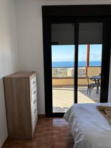 ein Schlafzimmer mit Bett und Meerblick in der Unterkunft Apartamento Vacacional Gara in Adeje