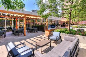a patio with tables and chairs and a restaurant at South Loop 1br w gym lounge nr Grant Park CHI-847 in Chicago