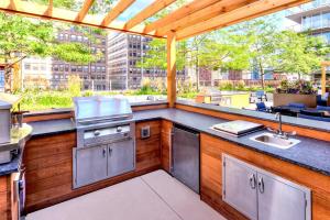 a large outdoor kitchen with a grill and a counter top at South Loop 1br w gym lounge nr Grant Park CHI-847 in Chicago