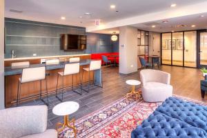 a lobby with a bar and some chairs and tables at South Loop 1br w gym lounge nr Grant Park CHI-847 in Chicago