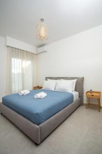 a bedroom with a large bed with two towels on it at Aetheria Central Apartments in Rhodes Town