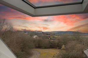 a painting of a sunset from a house at Roseland Apartment 5 in Arundel