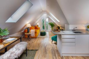 a kitchen and living room with an attic at Roseland Apartment 5 in Arundel