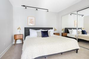 a white bedroom with a large bed with blue pillows at Redondo Beach 1BR w Pool Gym nr Beach LAX-396 in Redondo Beach +22 photos