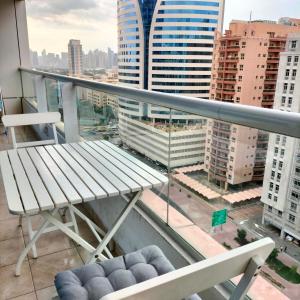 a balcony with a bench and a view of a city at Amazing apartment 2 bed rooms in Tecom 6 pax in Dubai
