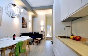 a kitchen and living room with a table and a dining room at [Luxury apartment near Niguarda] Graziano39 in Milan