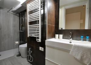 a bathroom with a sink and a toilet and a mirror at [Luxury apartment near Niguarda] Graziano39 in Milan