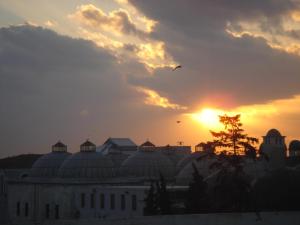 a bird flying over a building at sunset at Hotel SultanHill in Istanbul
