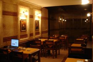 a dining room with tables and a laptop on a table at Hotel SultanHill in Istanbul