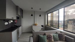 a living room with a couch and a large window at Maia Apartment in Maia