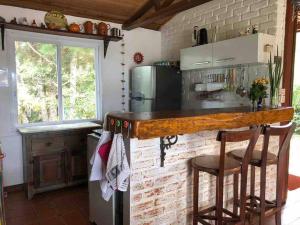 a kitchen with a counter and a brick wall at Casa das flores - Lavras Novas in Lavras Novas
