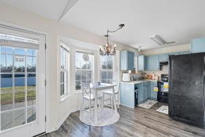 a kitchen with blue cabinets and a table at Hakuna Matata Hostel Shared Room in Charlotte