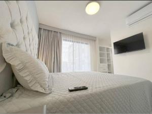 a bedroom with a bed with a remote control on it at Departamento Exclusivo, High Apartment with Great Location 4-B in Matamoros
