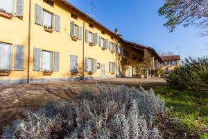 a large yellow building with a lot of windows at Cascina Bellaria in Milan
