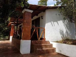 a brick building with stairs in front of it at Bosque Macadamia in El Tejar