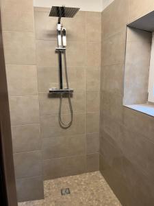 a shower with a shower head in a bathroom at Casa Restelli OG - nahe Andermatt Gotthard in Gurtnellen