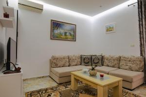 a living room with a couch and a table at Vila Jon'a in Sarandë