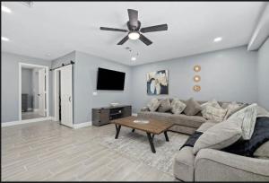 a living room with a couch and a ceiling fan at Clearwater Charm in Clearwater