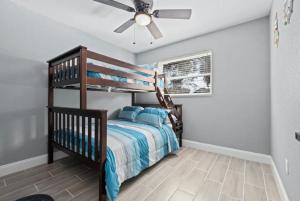 a bedroom with a bunk bed and a ceiling fan at Clearwater Charm in Clearwater