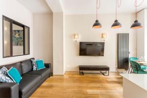Televízia a/alebo spoločenská miestnosť v ubytovaní Design et confort near Champs Elysees