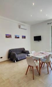 ein Wohnzimmer mit einem Tisch und einem Sofa in der Unterkunft Il Principe casa vacanze in Trabia