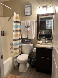 a bathroom with a toilet and a sink and a shower at Amazing Universal Studios Loft FREE parking in Los Angeles