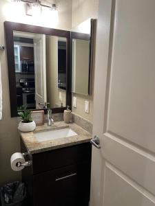 a bathroom with a sink and a large mirror at Amazing Universal Studios Loft FREE parking in Los Angeles