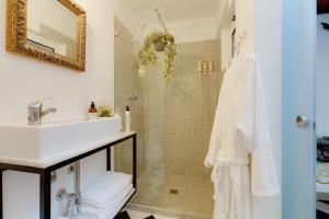 a bathroom with a sink and a shower at Your Vintage Townhouse in Lagos